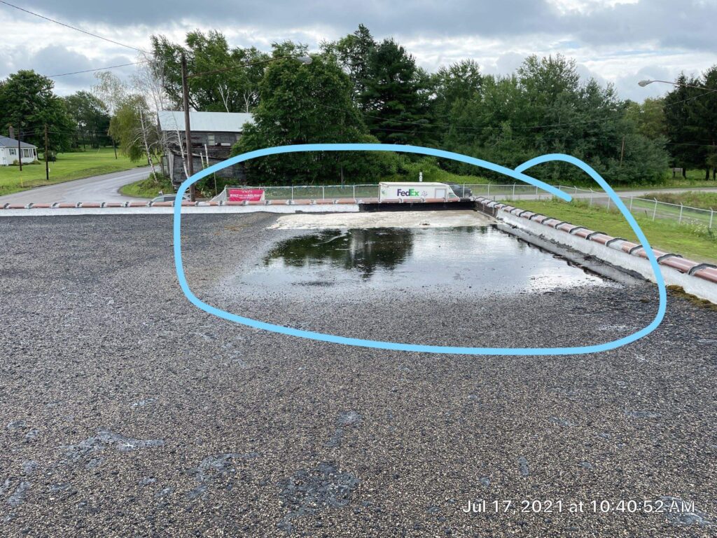 water ponding on a flat roof, leaking